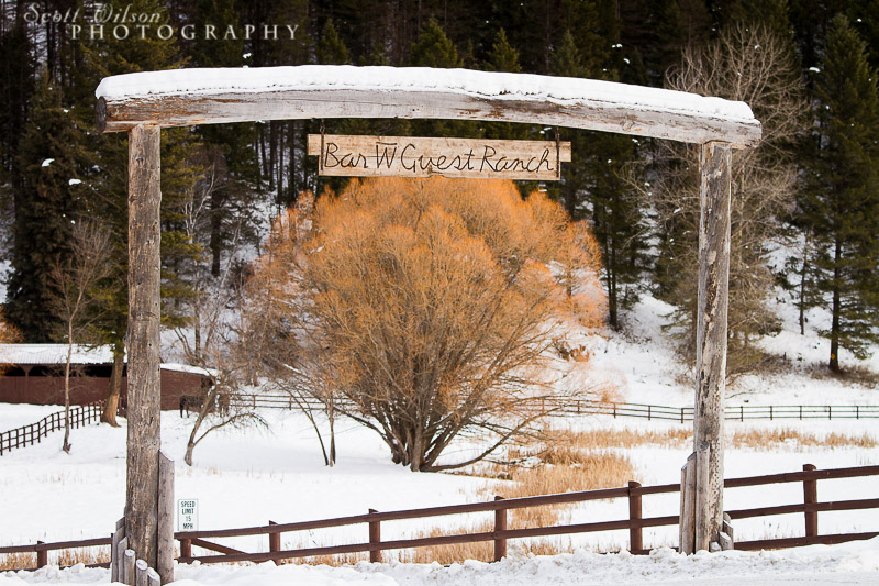 Rustic wooden sign marking entrance to Bar W Ranch in Whitefish, Montana.