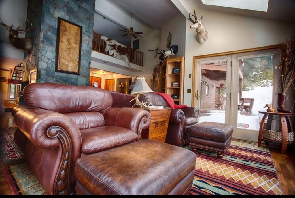 Comfortable ranch lounge with plush sofas and rustic decor.